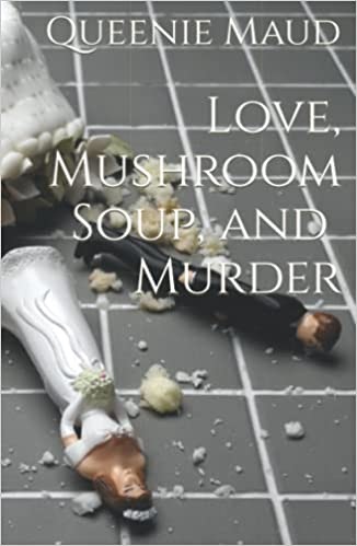 Image description: A picture of the cover of the special edition hardcover of Love, Mushroom Soup, and Murder: a fallen wedding cake, with a groom prop up right and a bride prop down left. Wedding cake crumbs are scattered, and the author's name "Queenie Maud" plus the title "Love, Mushroom Soup, & Murder" are in a white all-caps font set over the photo. 